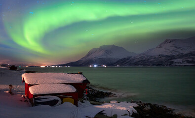 Northern lights or Aurora borealis in the sky over Tromso fjords - Tromso,  Norway