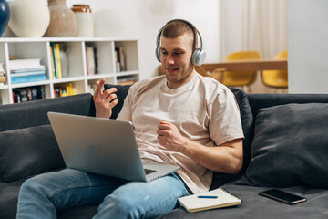 A young businessman is working on his laptop.