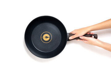 Fototapeta premium New Frying Pan in Hands Isolated on White