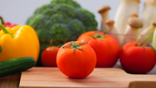 Healthy eating ingredients: fresh vegetables, fruits and superfood. Nutrition, diet, vegan food.showing the tomoto on table.