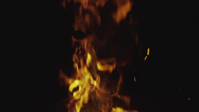 Fire and flames from burning rubber on dark background. Heat footage for templates and alpha channel editing pattern