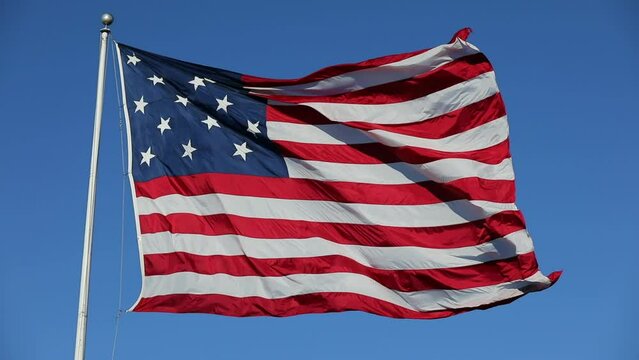 Waving USA Flag in Clear Blue Sky. USA American Flag. Waving United States of America Famous Flag. Sunny Day. Slow Motion.