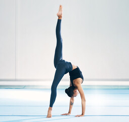 Gymnast, woman and cartwheel for training in gym, exercise and flexibility for mockup. Studio,...