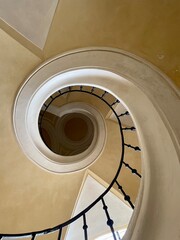 Fototapeta premium The spiral staircase in the Church of the Assumption of the Virgin Mary and St. John the Baptist in Kutna Hora. View from below, yellow plaster. High quality photo