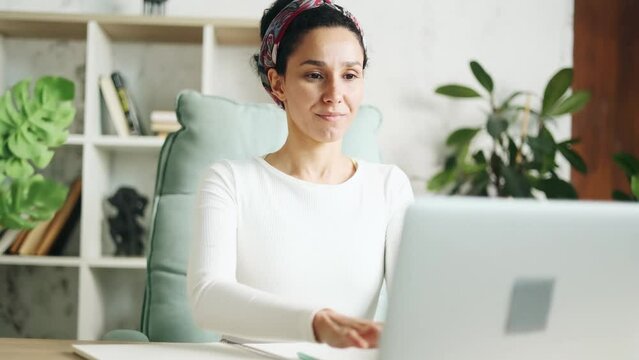 Portrait of young hispanic woman thinks questioningly finding solution and begin typing browsing on laptop computer at home Creative freelancer or student working on project indoors Idea concept