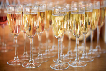 close up arranged glass on the table in abstract field in celebration time for any luxury background. many glasses of champagne, close-up, bokeh