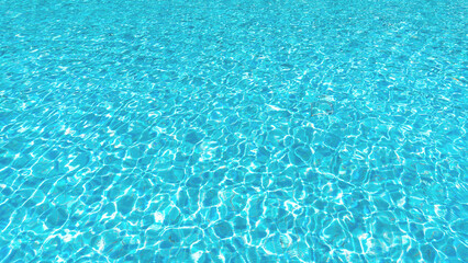 Water swimming pool background with texture surface pattern of blue turquoise ripple wavy water reflection of natural aqua wave on the outdoor summer holiday vacation pool