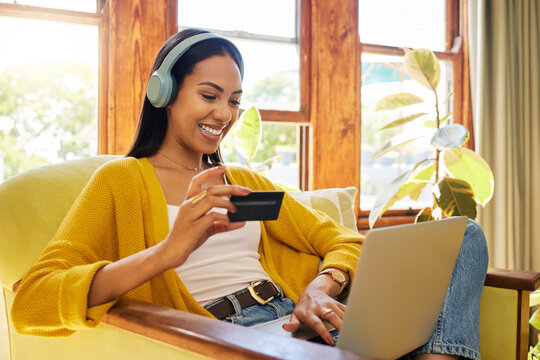 Woman, Laptop And Credit Card With Ecommerce And Headphones To Listen To Music While Online Shopping. Happy Female Relax At Home, Podcast Or Radio Streaming With Fintech, Internet Banking And Payment