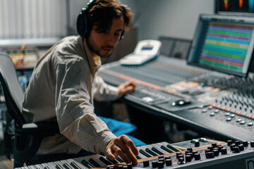 Male hands play electronic piano keyboard Fingers tap keys midi controller Musician produces song...