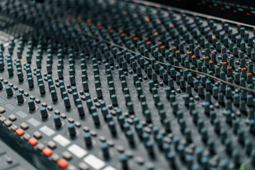 A recording studio control panel mixer with an equalizer faders buttons for broadcasting a...