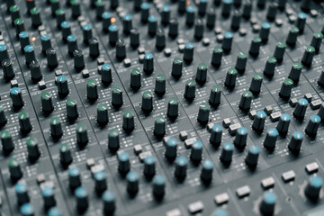Fototapeta premium A recording studio control panel mixer with an equalizer faders buttons for broadcasting a recording of a song