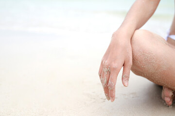 young woman sitting in relaxation outdoors on tropical beach with sand, body parts. Tanned sunbath girl in Lotus position yoga relax, and meditation. summer travel holiday concept.