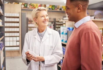 Zelfklevend Fotobehang Man shopping, medicine or happy pharmacist in pharmacy for retail healthcare information with a smile. Trust, woman or senior doctor helping a customer with medication advice, pills or medical drugs © Nina/peopleimages.com