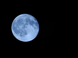 full blue moon in the night time sky