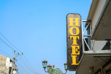 Fototapeta premium Old hotel sign with clear blue sky in Yogyakarta, Indonesia