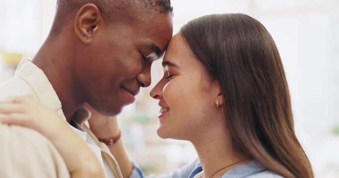 Hug, happy and an interracial couple in an embrace for love, gratitude and appreciation at home. Smile, together and a black man and woman hugging, embracing and being affectionate for closeness