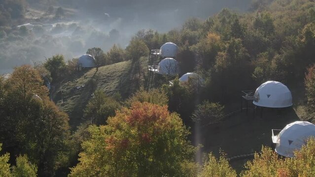 Aerial view of  isolated luxury glamping tents in the forest , Racha, Georgia .