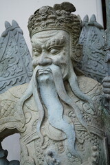 Obraz premium Sandstone sculptures dressed as ancient Chinese warriors in various poses at Wat Pho, Bangkok, Thailand.