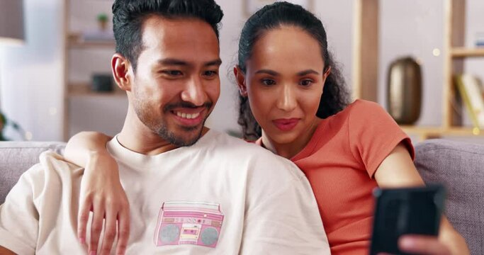 Phone, relax and home couple watch social media video, streaming subscription content or browse website. Love, hug and talking man, woman or online shopping people surfing internet on lounge sofa