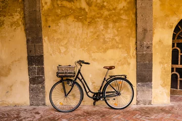 Deurstickers A bicycle leaning against the wall inside Saint Francis cloister in Sorrento, Italy © Valeria Venezia