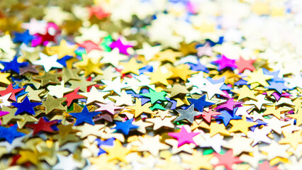 Fototapeta na wymiar Multi-colored shining stars close-up. Festive holiday background. 