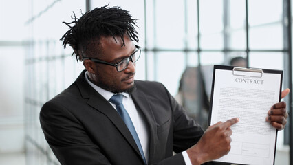 businessman shows documents financial reports to camera