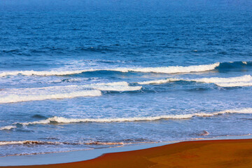 Ocean waves and sandy coast . Beautiful blue ocean 