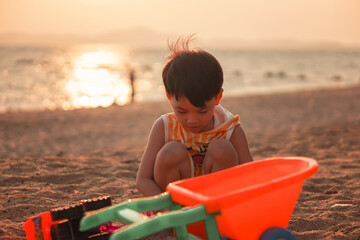 Kids playing on tropical beach. Children play at sea on summer family vacation. Sand and water...