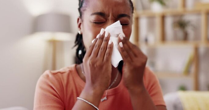 Sick, woman and tissue for blowing nose in home lounge, hayfever allergies and cold of winter virus. Young black female, sneeze and influenza allergy from health problem, covid risk and sinusitis