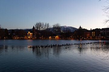 Frozen lake at sunset next to some houses