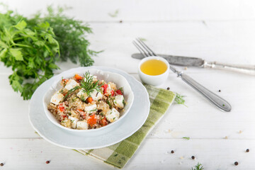 Fresh salad with quinoa, feta cheese and fresh tomatoes. Lean vegetarian. White wooden background.
