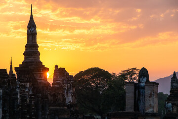 Ancient temples in Sukhothai Historical Park, Thailand, orange sunset