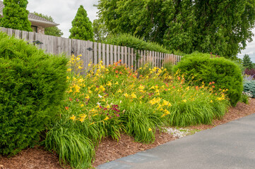 Flower Garden And Wooden Fence Along The Trail