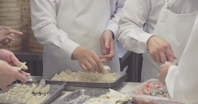 Hands cook and preparing dough of Chinese dumplings