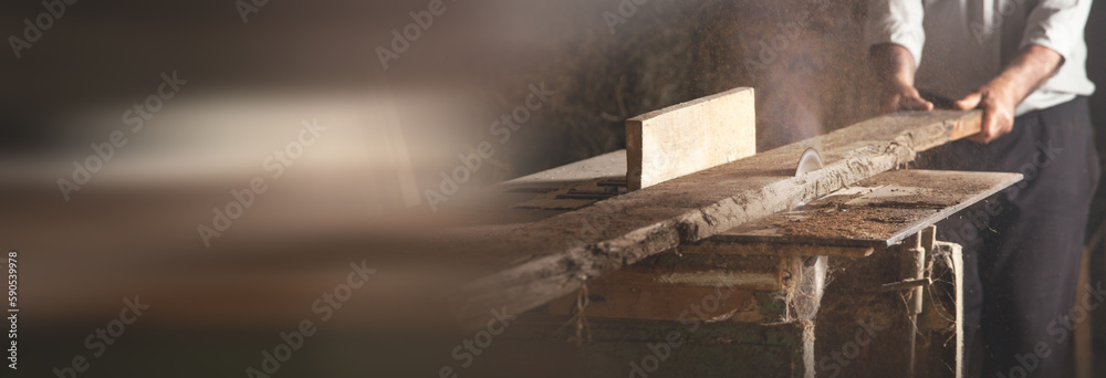 Wall mural Carpenter cutting a wooden plank with a carpentry machine.