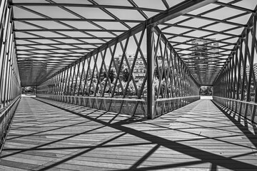 Black and white image Metallic structure of a double footbridge over the manzanares river in Madrid