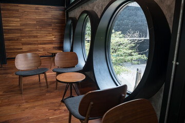 Plakat Coffee shop relax seats with outdoor view from circle windows