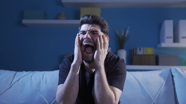 A man with schizophrenia with psychological problems.
Mentally ill man staying at home alone going crazy at home.		
