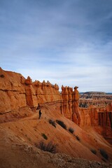 Vertical shot of a person standing on mountain in Bryce Canyon National Park, Utah, USA