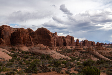 Fototapeta premium Clouds over unique desert formations in Utah Canyons