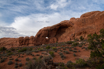 Fototapeta premium Clouds over unique desert formations in Utah Canyons