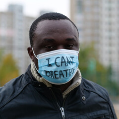 African american man activist in mask with an inscription I CANT BREATHE
