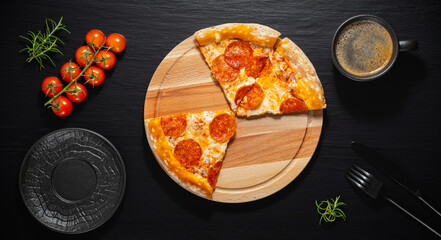 Fresh and hot Pizza pepperoni and coffee on a black background