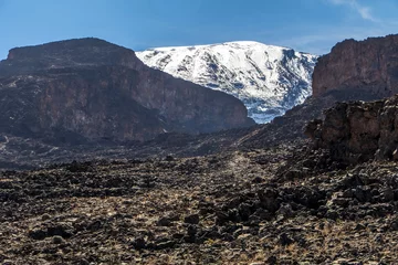 Papier Peint photo Kilimandjaro Scenery, rock piles and hiking trail on the slope of Mount Kilimanjaro