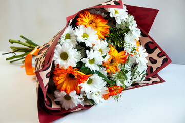Photo of a bouquet of orange and white flowers on a white background