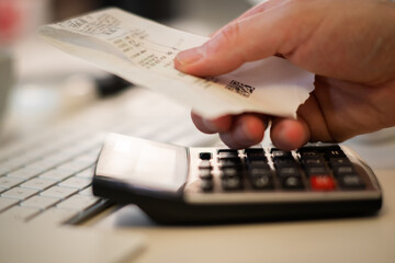 Counting on a calculator. Counting bills, home accounting office