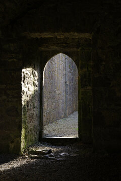light falling through a arched door in a ruined abbey in ireland
