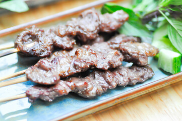 barbecued beef or grilled beef , beef satay with sauce