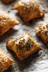 Puff pastry stuffed with spinach  and cheese sprinkled with mix of seeds, focus on the pastry inside. Delicious snack on the party.