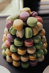 Plate with tasty, delicious and colourful macarons on table served for party.